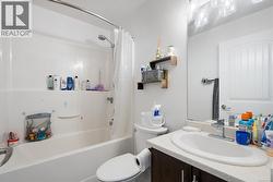 Bathroom with vanity and shower / bath combo with shower curtain -