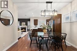 Dining room with a tile fireplace and dark wood-style floors -