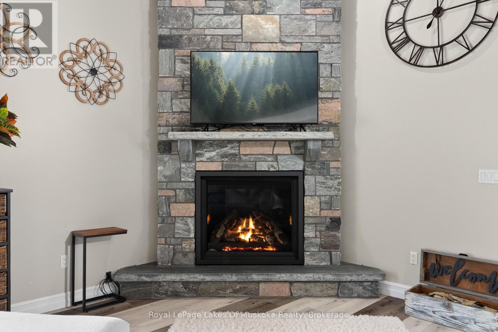 Handmade Granite Fireplace from Manitoulin Island. - 679 Boulder Road, South River, ON - Indoor Photo Showing Living Room With Fireplace