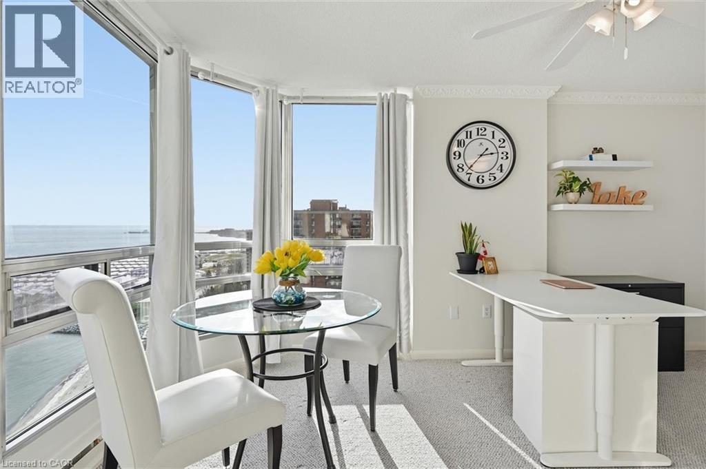 Dining space featuring light carpet, ceiling fan, and a water view - 2170 Marine Drive Unit# 1808, Oakville, ON