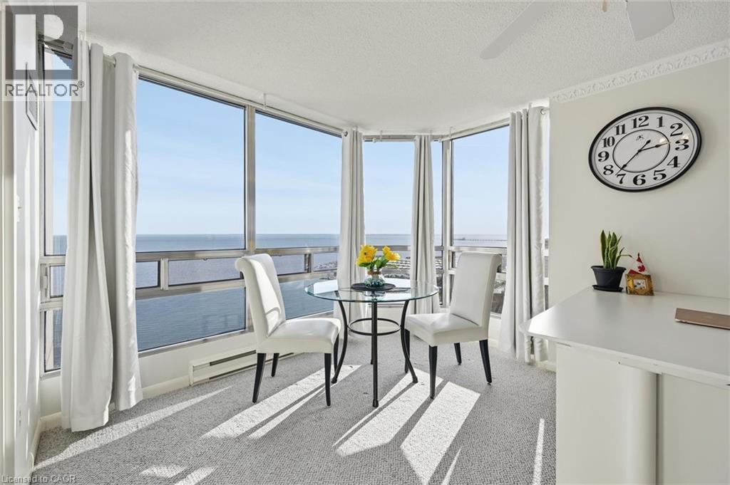 Dining room featuring a water view, light carpet, floor to ceiling windows, and a textured ceiling - 2170 Marine Drive Unit# 1808, Oakville, ON