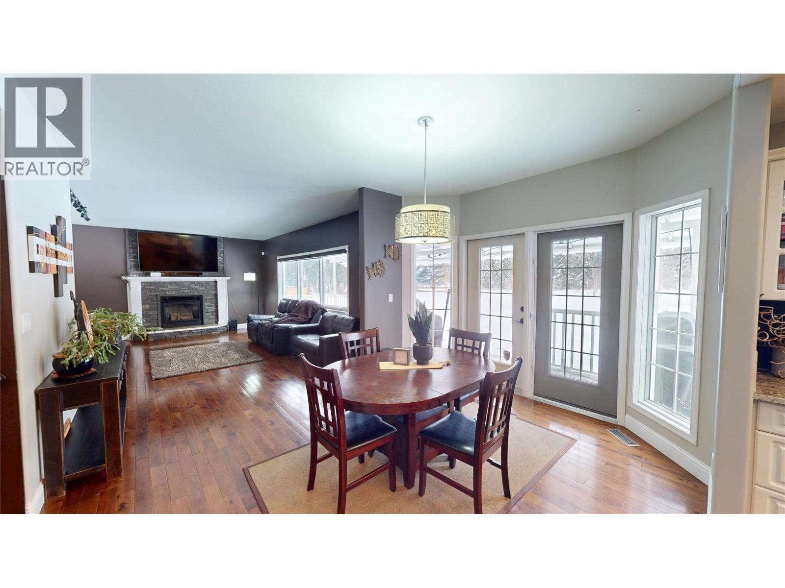 3320 5Th Street S, Cranbrook, BC - Indoor Photo Showing Dining Room With Fireplace