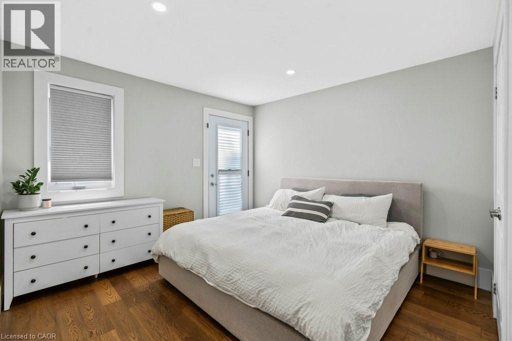 Primary bedroom with walkout to backyard deck - 18 Park Row N, Hamilton, ON