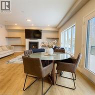 Dining space featuring light wood finished floors, a fireplace, and recessed lighting -