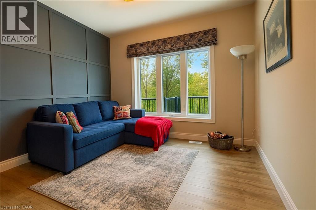 Living area with a decorative wall and light wood-style floors - 195 Water Street, St. Jacobs, ON - Indoor