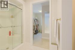 Full bath featuring a shower stall and a walk in closet -