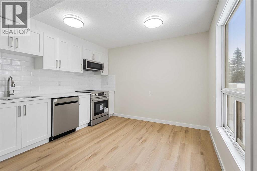 24, 64 Whitnel Court Ne, Calgary, AB - Indoor Photo Showing Kitchen With Stainless Steel Kitchen With Upgraded Kitchen