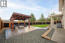Custom timber gazebo with stamped concrete patio and fire table -