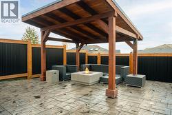Custom timber gazebo with stamped concrete patio and fire table -