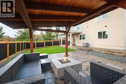 Custom timber gazebo with stamped concrete patio and fire table -