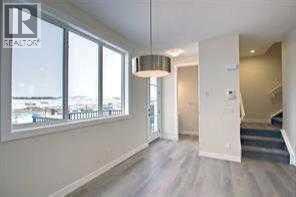 rear entry, 2pce powder room off dining area - 105 Cobbestone Gate Sw, Airdrie, AB - Indoor Photo Showing Other Room