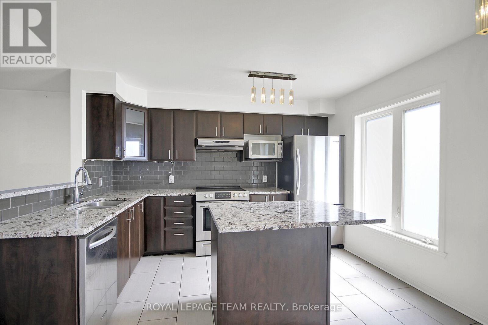 Bright Kitchen w/large window & patio door. - 151 - 1512 Walkley Road S, Ottawa, ON - Indoor Photo Showing Kitchen With Upgraded Kitchen