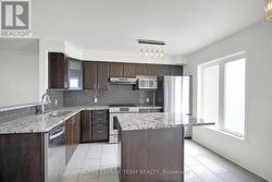 Bright Kitchen w/large window & patio door. -