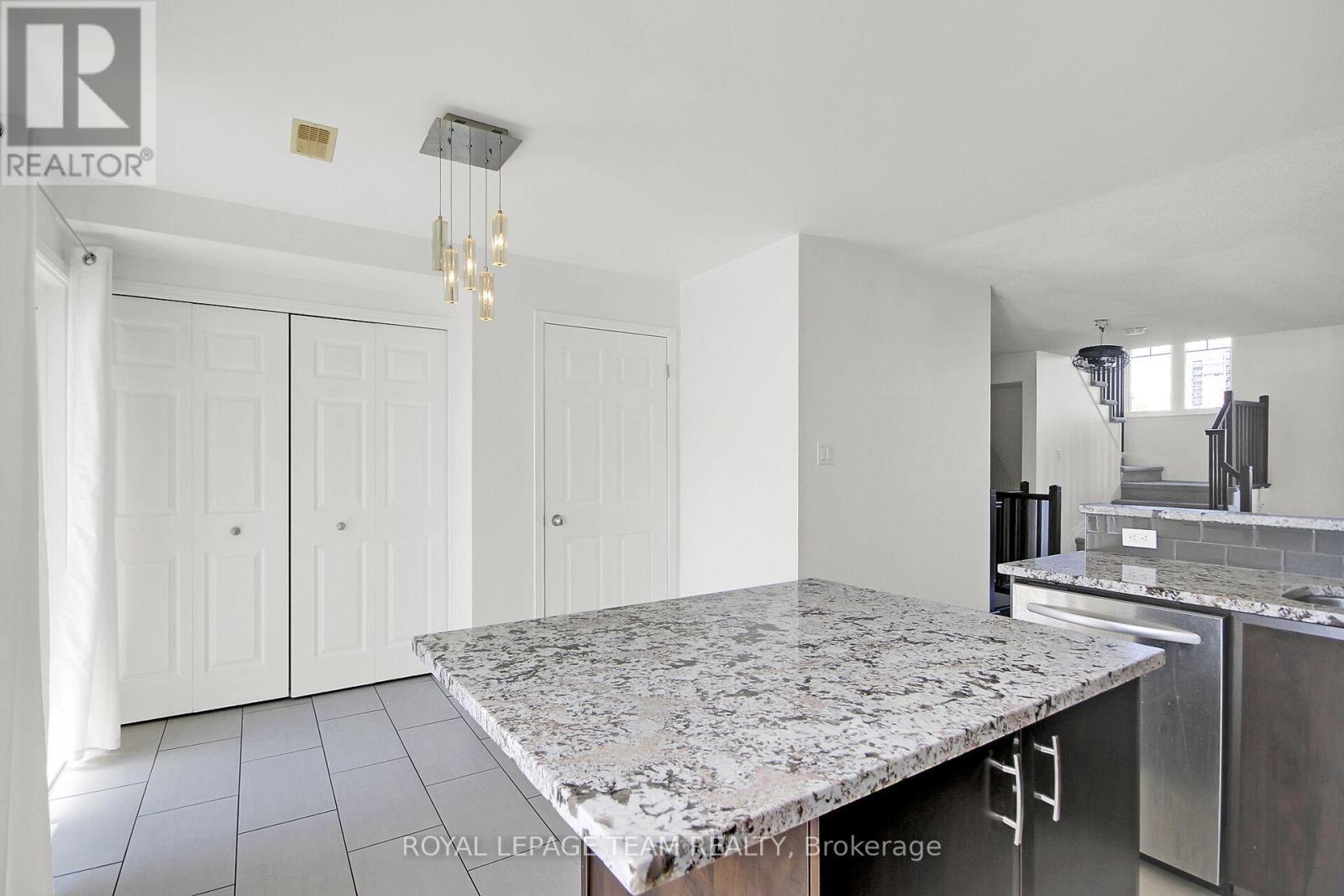 Large island in tiled Kitchen. - 151 - 1512 Walkley Road S, Ottawa, ON - Indoor Photo Showing Kitchen