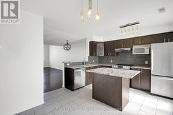 Tiled Kitchen with lots of natural light. -
