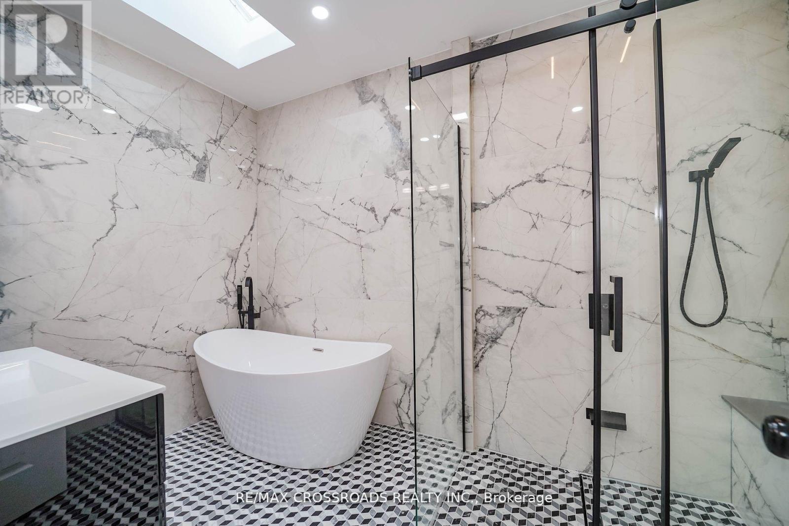 skylight free standing tub - 7118 Yonge Street, Innisfil, ON - Indoor Photo Showing Bathroom