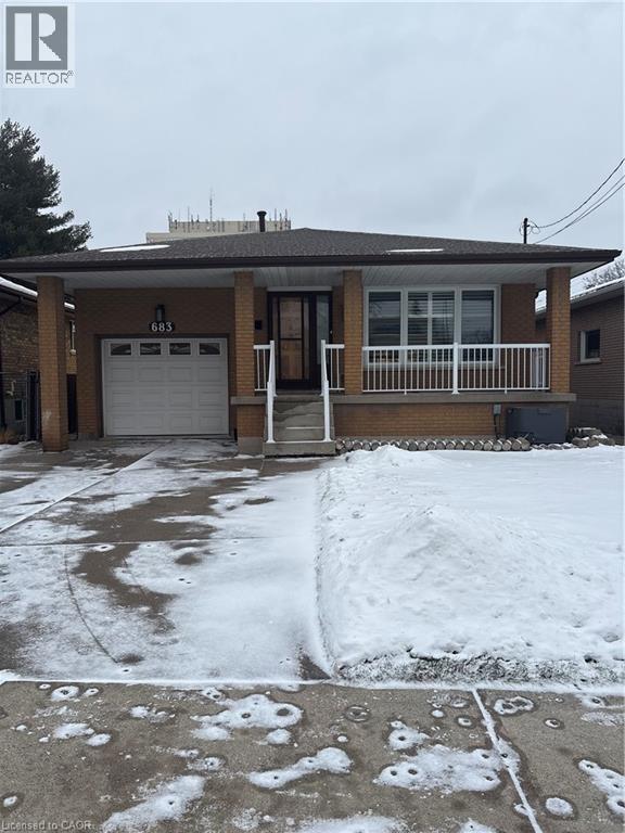 Ranch-style house with a porch, brick siding, a garage, and roof with shingles - 683 Seventh Avenue, Hamilton, ON