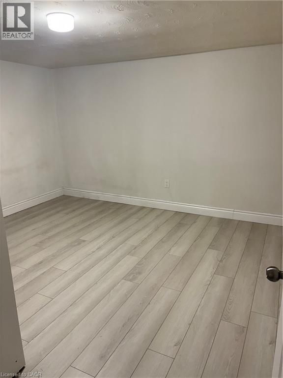 Spare room with light wood finished floors and a textured ceiling - 683 Seventh Avenue, Hamilton, ON