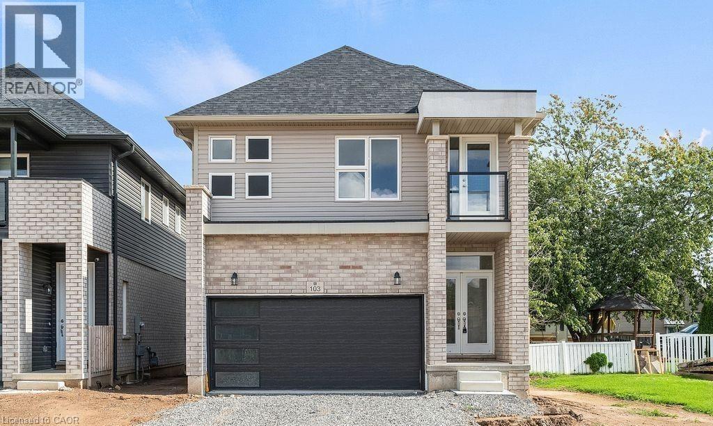 View of front of home with a balcony, brick siding, gravel driveway, a shingled roof, and a garage - 103 Mclaughlin Street, Welland, ON - Outdoor With Facade
