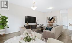 Living area featuring wood finished floors and baseboards -