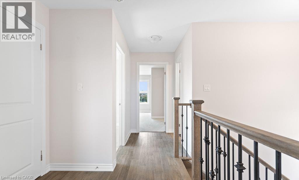 Hall with dark wood-style flooring and an upstairs landing - 103 Mclaughlin Street, Welland, ON - Indoor Photo Showing Other Room