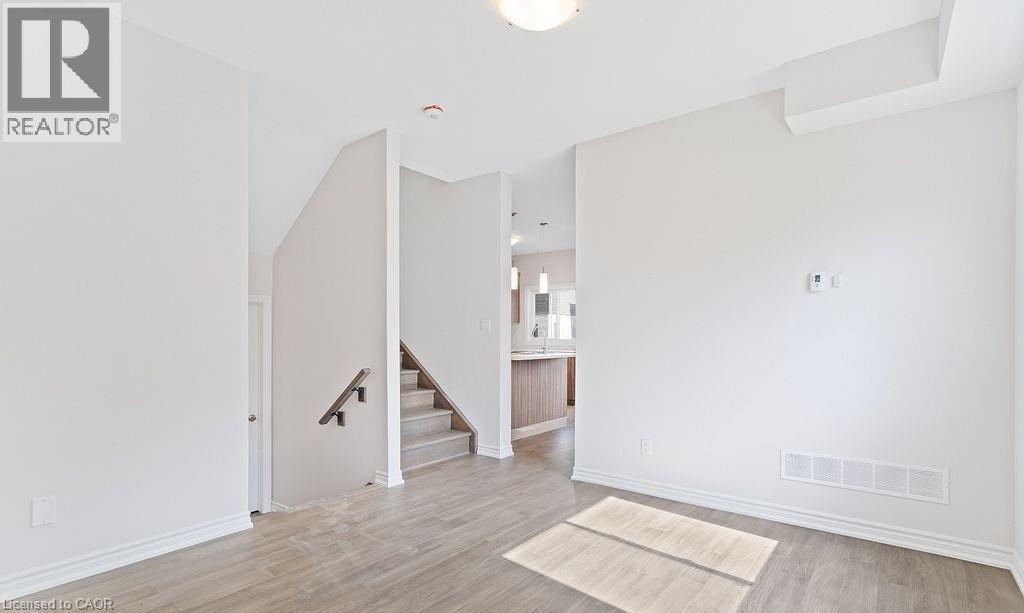 Spare room featuring light wood-type flooring and stairs - 103 Mclaughlin Street, Welland, ON - Indoor Photo Showing Other Room
