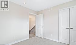Unfurnished bedroom with carpet floors and a closet -