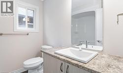 Bathroom featuring vanity and toilet -