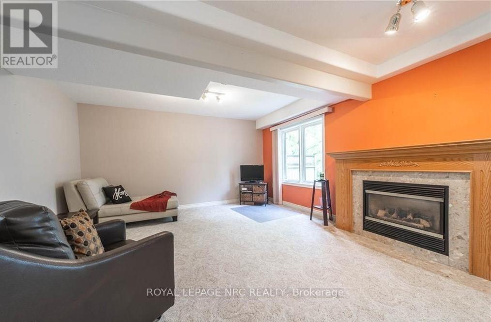 25 - 174 Martindale Road, St. Catharines (Grapeview), ON - Indoor Photo Showing Living Room With Fireplace