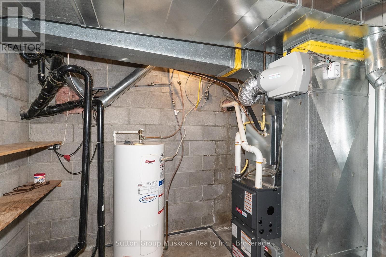 Hot water tank (Reliance) - 64 Spruce Drive, Huntsville (Stephenson), ON - Indoor Photo Showing Basement