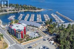 Drone / aerial view of a marina and a nearby body of water -