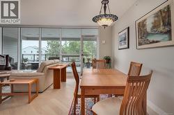 Dining room with light wood finished floors and floor to ceiling windows -
