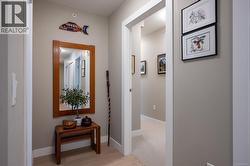 Hallway featuring light wood finished floors and baseboards -