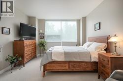 Bedroom with light carpet and baseboards -