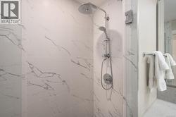 Full bathroom with a marble finish shower -