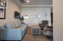 Living room with recessed lighting and a paneled ceiling -