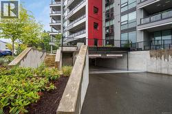 View of apartment building / complex featuring parking -