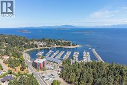 Drone / aerial view of a marina and a nearby body of water -