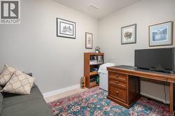 Office area with baseboards and light wood finished floors -