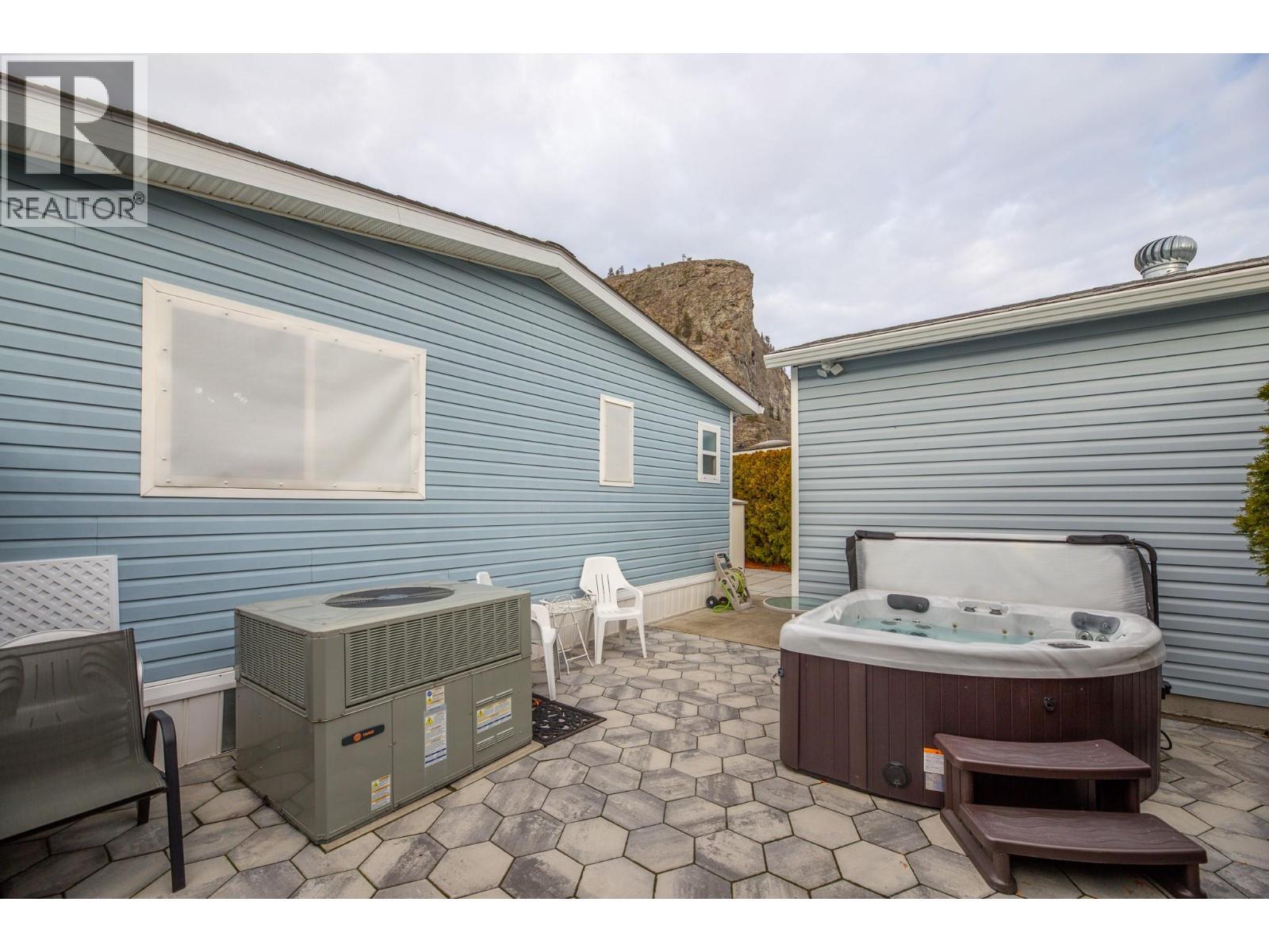 Back yard with EZ Snap window screens, stops sun & heat from hitting window - 8598 Hwy 97 Unit# 50, Oliver, BC