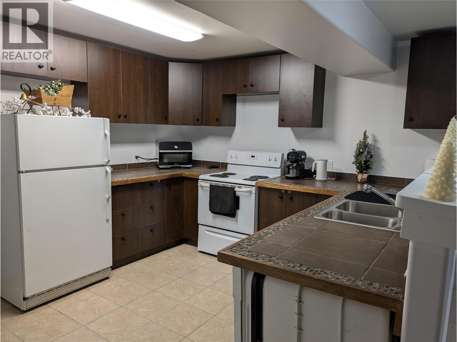 Lower Level - 3576 Rose Road, Kelowna, BC - Indoor Photo Showing Kitchen With Double Sink