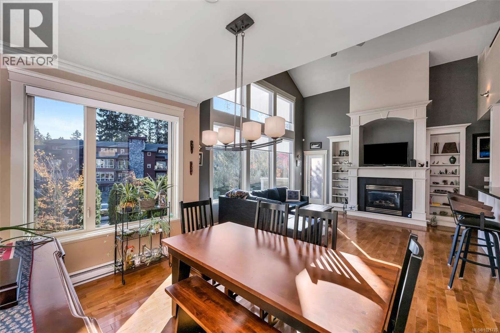 1 630 Brookside Rd, Colwood, BC - Indoor Photo Showing Dining Room With Fireplace