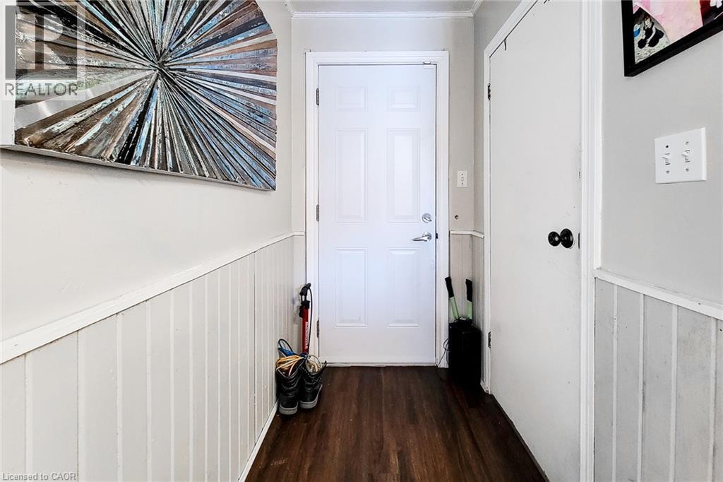 Entryway featuring wainscoting, ornamental molding, and wood finished floors - 558 Barnaby Street, Hamilton, ON - Indoor Photo Showing Other Room
