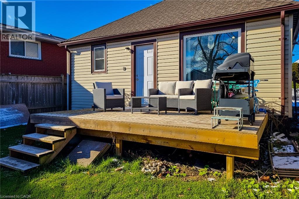 Wooden terrace featuring an outdoor living space and a grill - 558 Barnaby Street, Hamilton, ON - Outdoor With Deck Patio Veranda