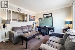 Living room featuring crown molding and carpet floors -