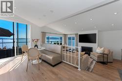 Living area with vaulted ceiling, vaulted ceiling and gas fireplace -