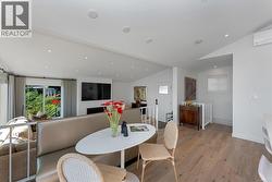 Dining area featuring hardwood floors, lofted ceiling and heat pump -