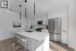 Kitchen island can accommodate 3 seated guests -