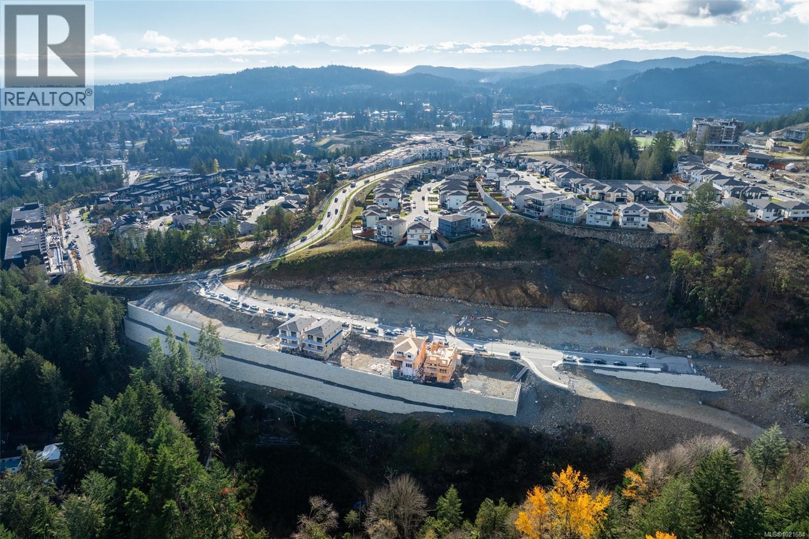 Aerial view of property and surrounding area featuring mountains and nearby suburban area - 1204 Cedarbrook Way, Langford, BC