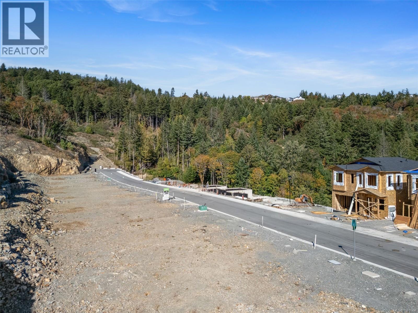 View of asphalt street with a wooded view - 1204 Cedarbrook Way, Langford, BC